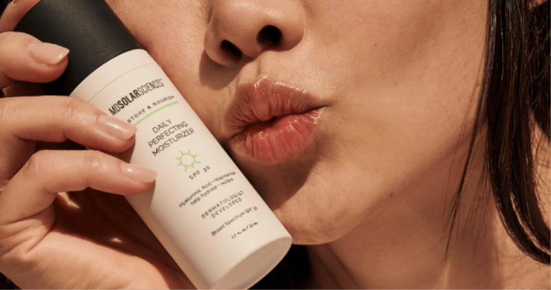 Image of woman's lips kissing MD Solar Sciences product