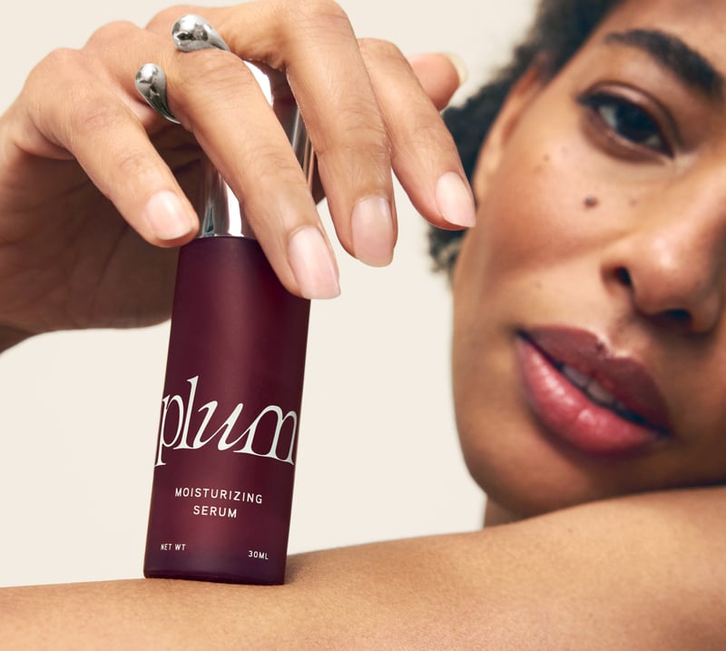 Model holding Plum moisturizing serum