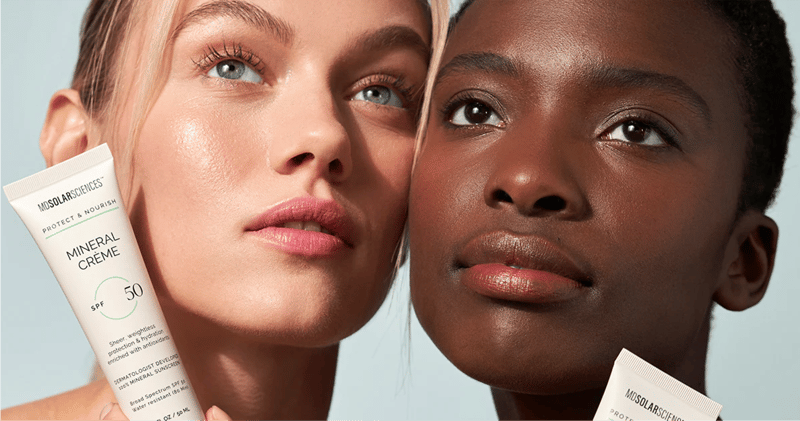 Two women hold the MD Solar Science SPF mineral creme